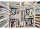 Well-organized walk-in closet with ample storage for clothes, shoes and accessories at 9015 Spruce Creek Cir, Riverview, FL 33578