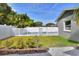 The fenced backyard features a sparkling pool, lush grass, and secure gate for privacy and enjoyment at 13032 Cumberland Dr, Largo, FL 33773