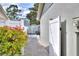 The paved path leads to a backyard oasis with a shed and patio set framed by lush landscaping at 13032 Cumberland Dr, Largo, FL 33773