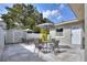 The backyard boasts dual patio sets, a storage shed, and a secure white fence, perfect for outdoor relaxation at 13032 Cumberland Dr, Largo, FL 33773