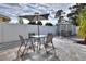 Backyard view features dual patio dining sets and a storage shed within a fenced, private outdoor living space at 13032 Cumberland Dr, Largo, FL 33773