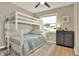 Bedroom featuring a bunk bed, a dresser, and a window with natural light at 13032 Cumberland Dr, Largo, FL 33773