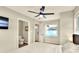 Comfortable bedroom showcasing stylish accents, a ceiling fan, and convenient access to the en suite at 13032 Cumberland Dr, Largo, FL 33773