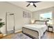 Bedroom features a queen-sized bed, ceiling fan, accent rug and a full-length mirror at 13032 Cumberland Dr, Largo, FL 33773