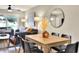Dining room adjacent to the living room with a round mirror, hardwood floors and natural lighting at 13032 Cumberland Dr, Largo, FL 33773