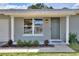 Inviting front entrance featuring a quaint one-story home with lovely landscaping at 13032 Cumberland Dr, Largo, FL 33773