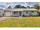 Lovely one-story home featuring a lush green lawn, neutral siding, and a welcoming entrance at 13032 Cumberland Dr, Largo, FL 33773