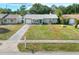 Inviting one-story home with a spacious front yard, driveway, and charming curb appeal at 13032 Cumberland Dr, Largo, FL 33773