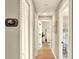 Hallway view showing hallway thermostat and entry into the adjacent bedrooms and living spaces at 13032 Cumberland Dr, Largo, FL 33773