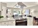 Open kitchen with island flows into a living area with comfortable seating and great views at 13032 Cumberland Dr, Largo, FL 33773
