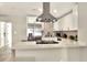 Bright kitchen featuring quartz countertops, stainless steel appliances, and mosaic backsplash at 13032 Cumberland Dr, Largo, FL 33773