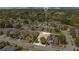 Aerial view of property lines in a suburban neighborhood with mature trees and nearby shopping at 14385 Saltby Pl, Spring Hill, FL 34609