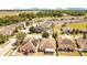 Aerial view of houses in a neighborhood, showcasing green trees, solar panels, and nearby highway at 14385 Saltby Pl, Spring Hill, FL 34609