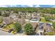 Aerial view of neighborhood homes with mature trees; some homes feature solar panels at 14385 Saltby Pl, Spring Hill, FL 34609