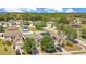 Aerial view of single-Gathering homes in a neighborhood featuring mature trees and solar panels on roofs at 14385 Saltby Pl, Spring Hill, FL 34609
