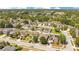 Aerial view of suburban homes featuring mature trees, solar panels, and community landscaping at 14385 Saltby Pl, Spring Hill, FL 34609