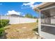 Fenced backyard showing property line and solar panels on roof of adjacent home on a sunny day at 14385 Saltby Pl, Spring Hill, FL 34609