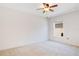 Bright bedroom with neutral carpet, a ceiling fan, and a large window providing natural light at 14385 Saltby Pl, Spring Hill, FL 34609