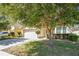 Attractive home featuring mature landscaping and a well-maintained lawn, with a two-car garage at 14385 Saltby Pl, Spring Hill, FL 34609