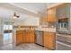 Bright kitchen features stainless steel appliances, wood cabinets and tile backsplash at 14385 Saltby Pl, Spring Hill, FL 34609