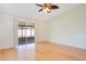 Bright room featuring hardwood floors and a sliding glass door to the outdoors at 14385 Saltby Pl, Spring Hill, FL 34609