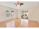 Cozy living area with hardwood floors, ceiling fan, a sliding glass door to the outdoors at 14385 Saltby Pl, Spring Hill, FL 34609