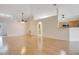 Bright and airy living room with light hardwood floors, a ceiling fan, and arched doorway at 14385 Saltby Pl, Spring Hill, FL 34609