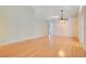 Expansive living room featuring hardwood floors, a ceiling fan, and neutral paint tones at 14385 Saltby Pl, Spring Hill, FL 34609