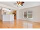 Hardwood floors, large window, and view into the kitchen make this a bright and welcoming space at 14385 Saltby Pl, Spring Hill, FL 34609