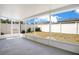 Screened-in back porch shows access to the backyard with a white fence under a blue sky at 14385 Saltby Pl, Spring Hill, FL 34609
