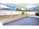 Covered and screened-in back patio providing view of the fenced backyard under a blue sky at 14385 Saltby Pl, Spring Hill, FL 34609