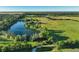 Expansive aerial view showcasing land, fields, and private lake at 701 E 60 Hwy, Plant City, FL 33567