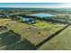 Aerial view of property featuring a home, outbuilding and private pond at 701 E 60 Hwy, Plant City, FL 33567