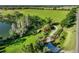 Aerial view of property with a pond, mature trees, and manicured lawn at 701 E 60 Hwy, Plant City, FL 33567