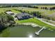 Aerial view of a home next to a pond with a dock, showcasing the expansive property and waterside location at 701 E 60 Hwy, Plant City, FL 33567