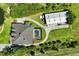 Aerial view of a home with a pool, outbuilding, and long driveway at 701 E 60 Hwy, Plant City, FL 33567