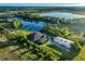 Aerial view of a home with a screened lanai, outbuilding and private pond at 701 E 60 Hwy, Plant City, FL 33567