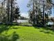 Picturesque backyard with lush green lawn and serene lake view at 701 E 60 Hwy, Plant City, FL 33567