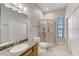 Clean bathroom with a glass enclosed shower and matching granite vanity top at 701 E 60 Hwy, Plant City, FL 33567