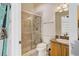 Bathroom with a glass-enclosed shower, toilet, and granite vanity, offering a clean and functional space at 701 E 60 Hwy, Plant City, FL 33567