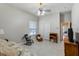 Neutral secondary bedroom with a ceiling fan, rocking chair, and convenient closet access at 701 E 60 Hwy, Plant City, FL 33567