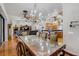 Open-concept dining area with wood floors, chandelier, and adjacent to kitchen and living spaces at 701 E 60 Hwy, Plant City, FL 33567