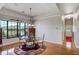 Elegant dining area with large windows offering picturesque lake views and a stylish round table at 701 E 60 Hwy, Plant City, FL 33567