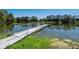 Long dock on calm pond, offering tranquil views and access for waterside enjoyment and recreation at 701 E 60 Hwy, Plant City, FL 33567