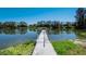 Inviting dock on a calm pond, providing a perfect spot for fishing, boating, or enjoying the serene waterfront views at 701 E 60 Hwy, Plant City, FL 33567