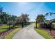 Grand gated entrance leading to the property with a landscaped driveway at 701 E 60 Hwy, Plant City, FL 33567
