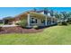 Attractive home with a covered porch, lush lawn, and well-maintained landscaping, including shade trees at 701 E 60 Hwy, Plant City, FL 33567