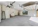 Bright garage interior with white walls, a ceiling fan, door to outside, and potential for various uses at 701 E 60 Hwy, Plant City, FL 33567