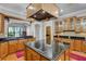 Bright kitchen features granite counters, wood cabinetry, cooktop island and archway leading to adjacent rooms at 701 E 60 Hwy, Plant City, FL 33567