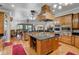 Gourmet kitchen with wood cabinets, stainless steel appliances, island and dining area with sliding glass doors at 701 E 60 Hwy, Plant City, FL 33567